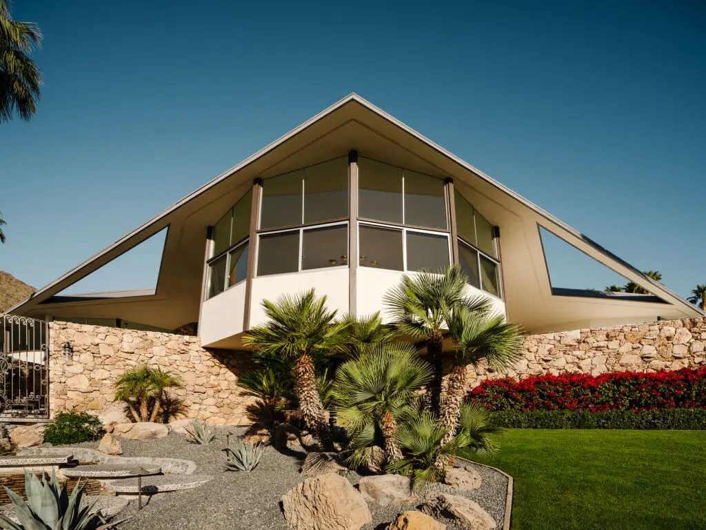 Imagine stepping into a time capsule where the future of architecture meets the charm of history. That's precisely what the House of Tomorrow offers. Located amidst the picturesque backdrop of the San Jacinto Mountains, this architectural gem was commissioned by the Alexander Construction Company and masterfully crafted by renowned architect William Krisel in 1960. With its unique design of four interconnected circular structures, the house provides stunning panoramic views that make it seem as if it were a spacecraft poised above the desert sands. Elvis Presley and his bride Priscilla had initially set their sights on marrying at this very location in the spring of 1967. However, swamped by media attention, they opted for a Las Vegas wedding and reserved the House of Tomorrow as their honeymoon retreat, earning it the charming nickname "Honeymoon Hideaway." This residence became symbolic of the glittering lifestyle of the 60s, where the living room's rock wall and a spacious pool beckoned partygoers looking for an escape into luxury.